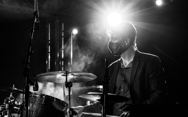 Black and white image of musicians performing on stage