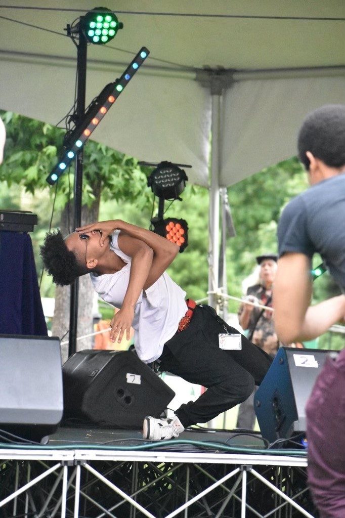 Image of a dancer dancing on an outside stage