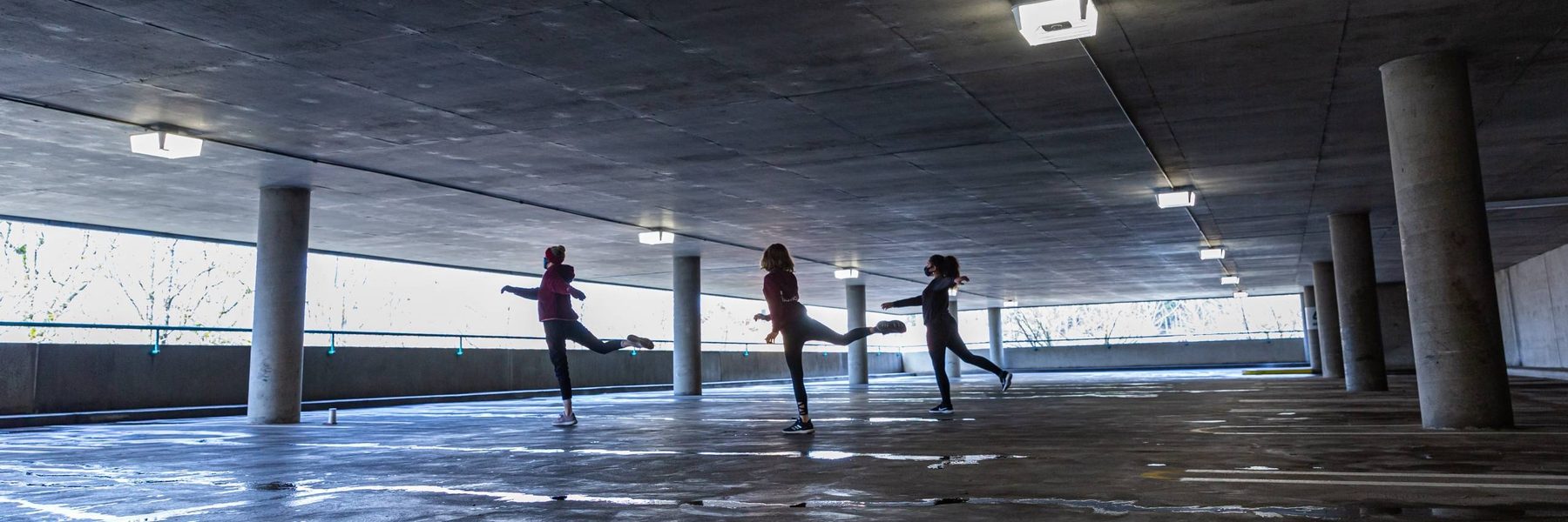 Image of dancers performing in a parking garage