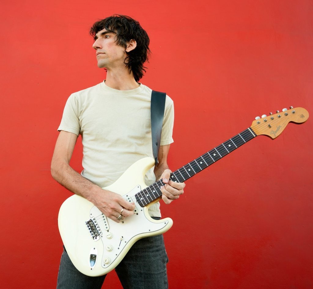 Delicate Steve holding a guitar