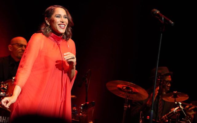 Woman on stage in front of microphone