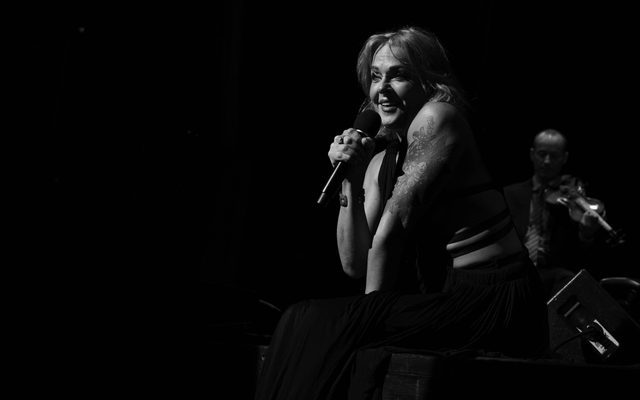 Black and white photo of a woman holding a microphone