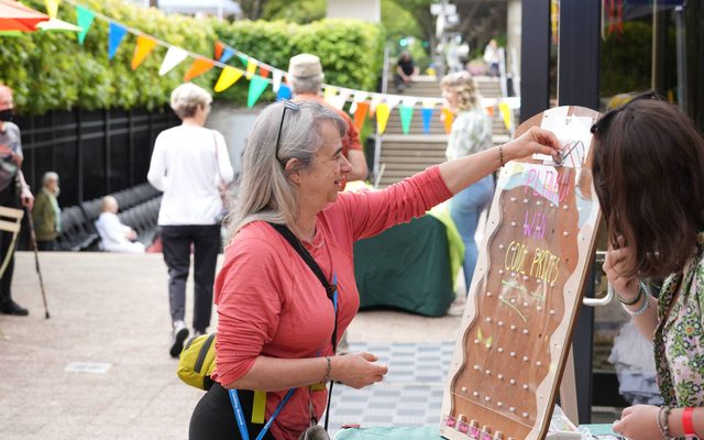 Woman playing a game outside of the Hult Center