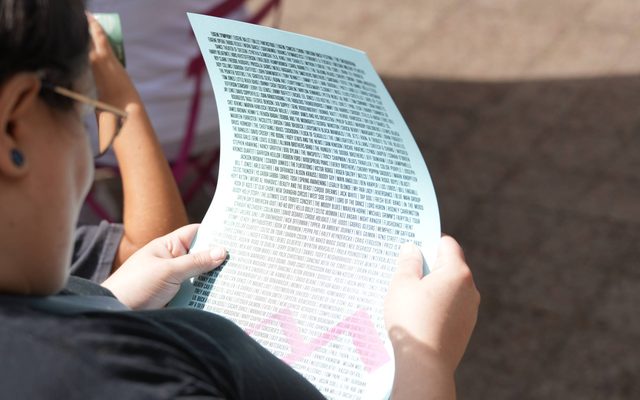 An individual holding a Hult Center poster