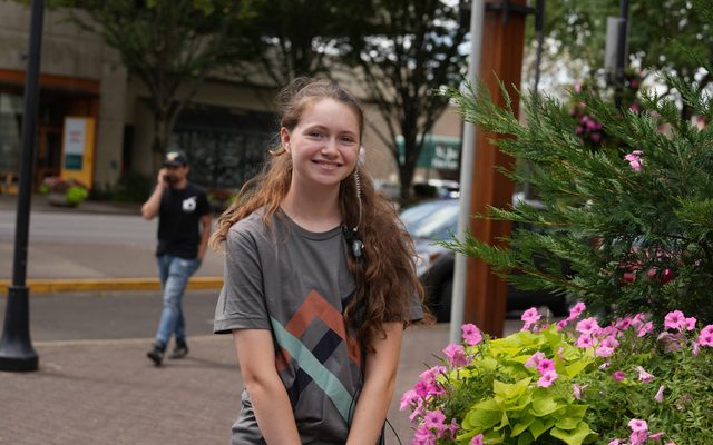 A young girl smiling outside of the Hult center