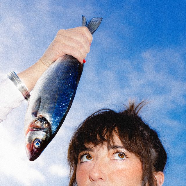 A colorful picture image of a woman holding a fish with the sky in the background